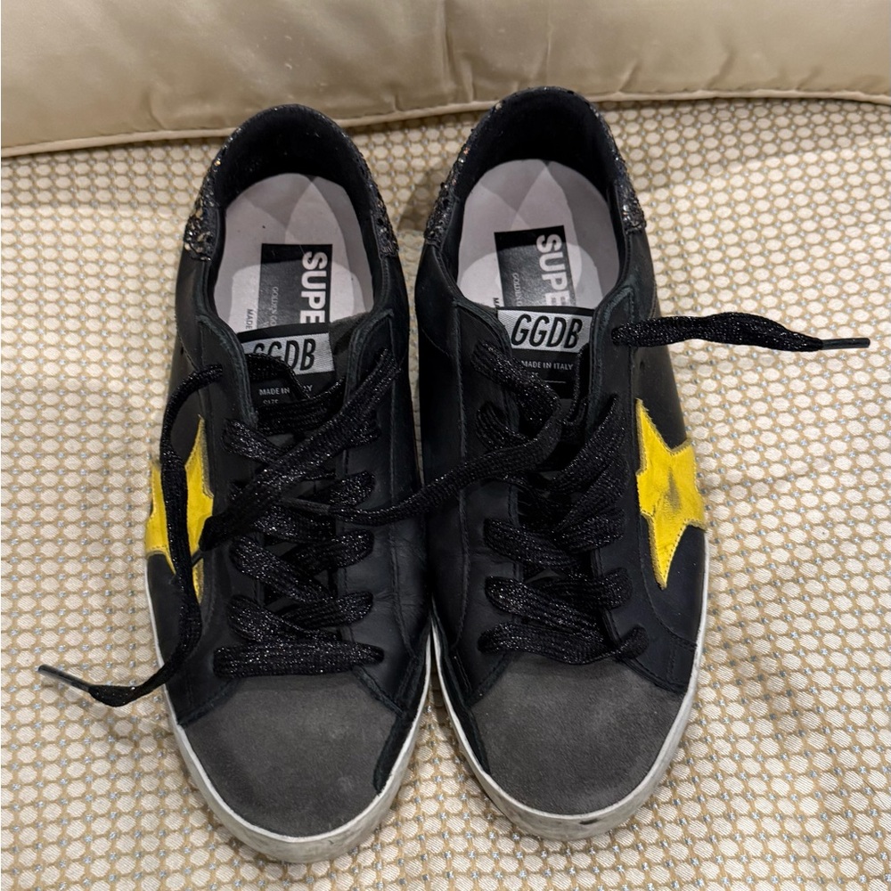 Golden Goose Superstar black glitter sneaker with yellow star